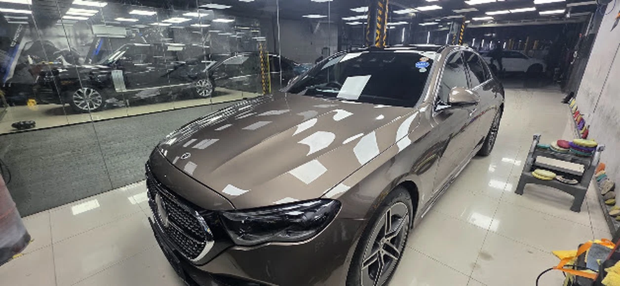 Completed vehicle with mirror-gloss clearcoat reflections inside the RestorFX Sri Lanka workshop bay